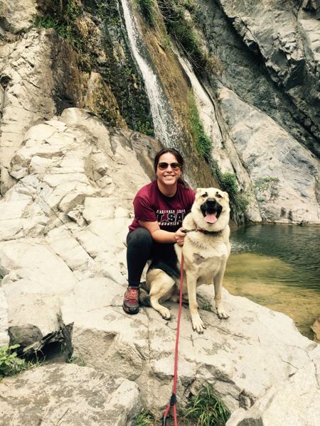 Candace and a happy pup on a waterfall hike